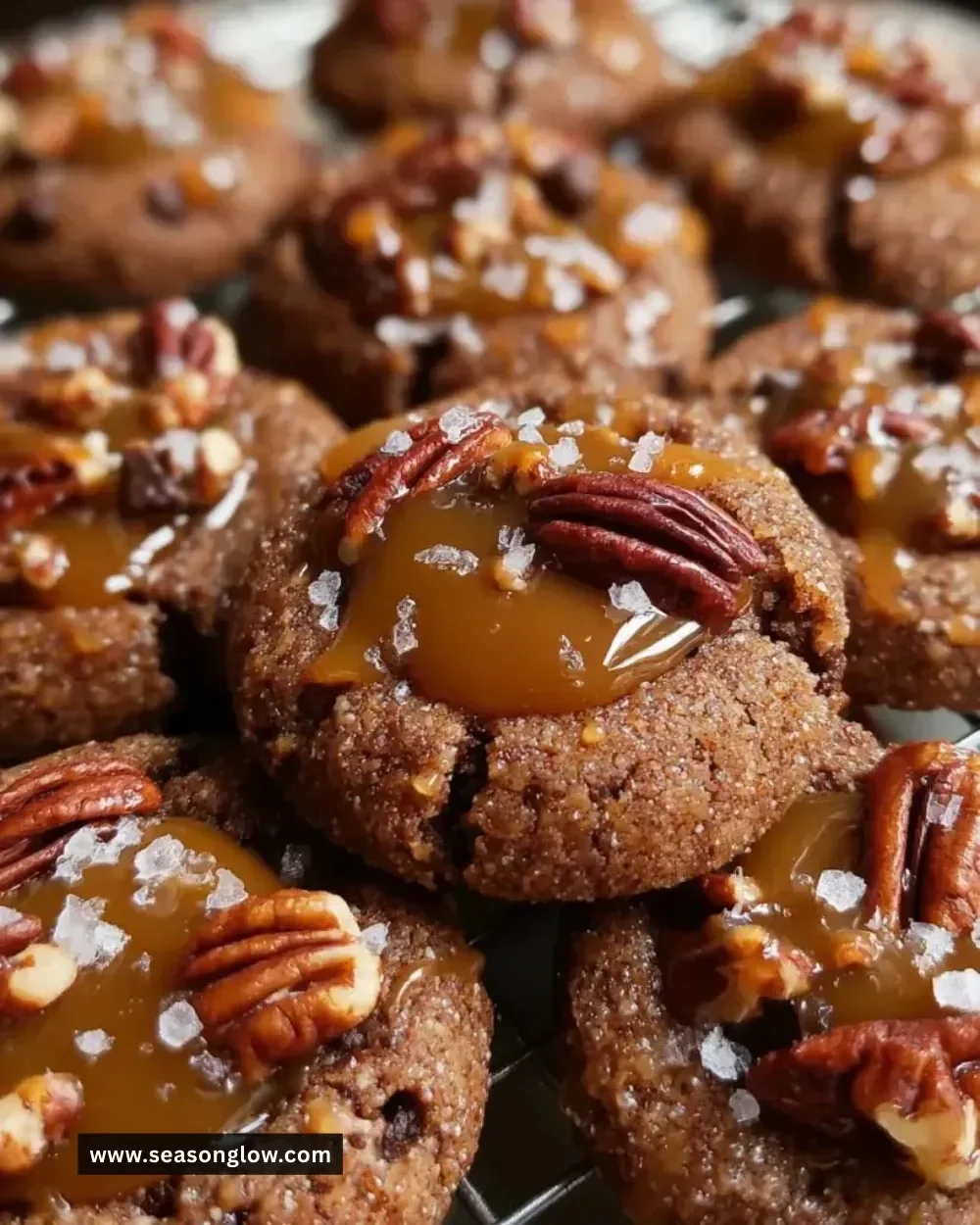 Pecan Caramel Thumbprint Cookies with caramel and pecans on white plate