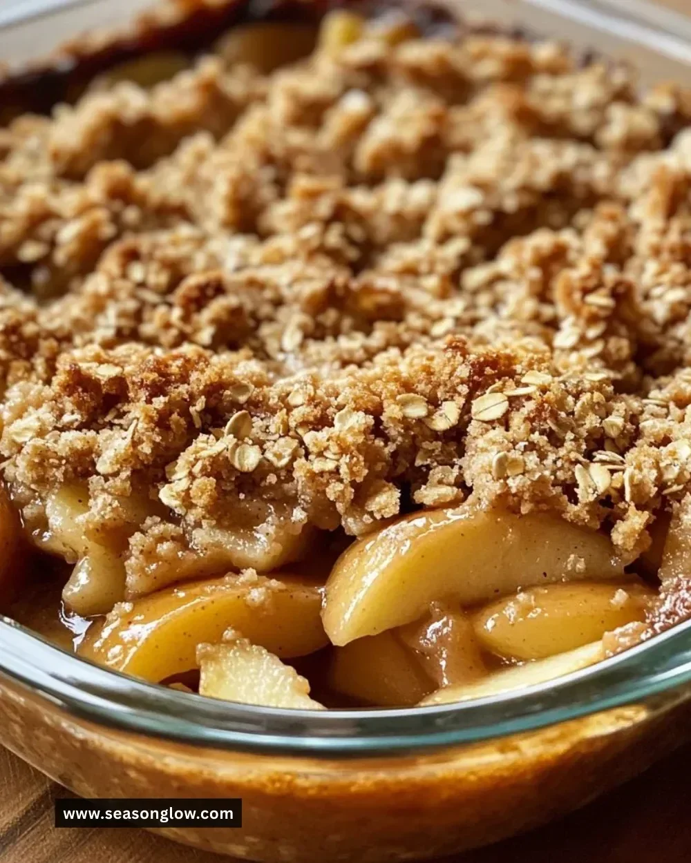 Pioneer Woman's apple crisp served in a bowl with ice cream on top.