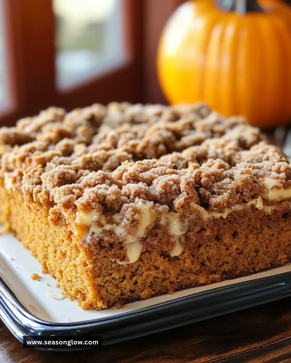 Delicious Pumpkin Coffee Cake topped with cream cheese icing and cinnamon