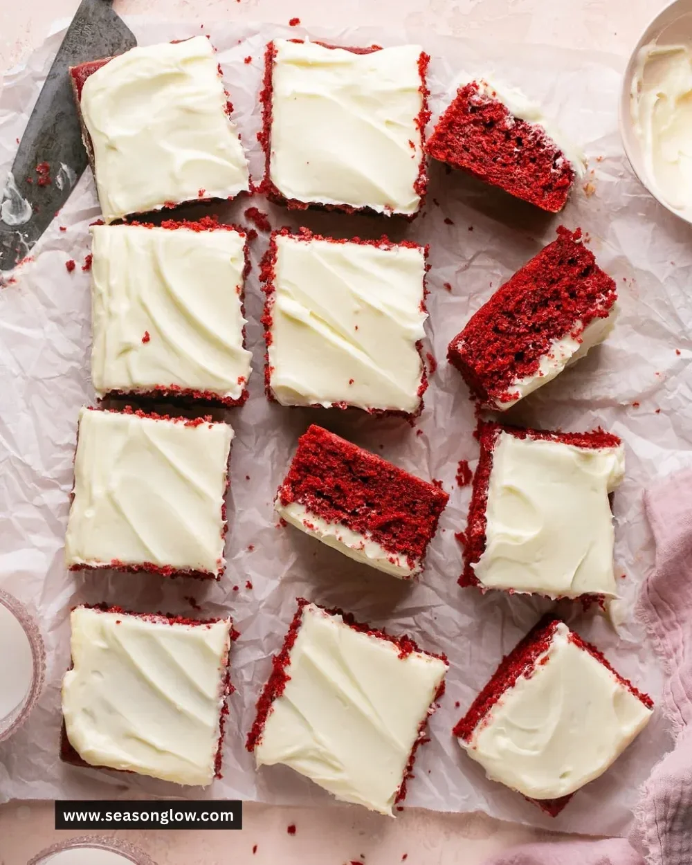 Delicious red velvet cake with cream cheese frosting on a white plate