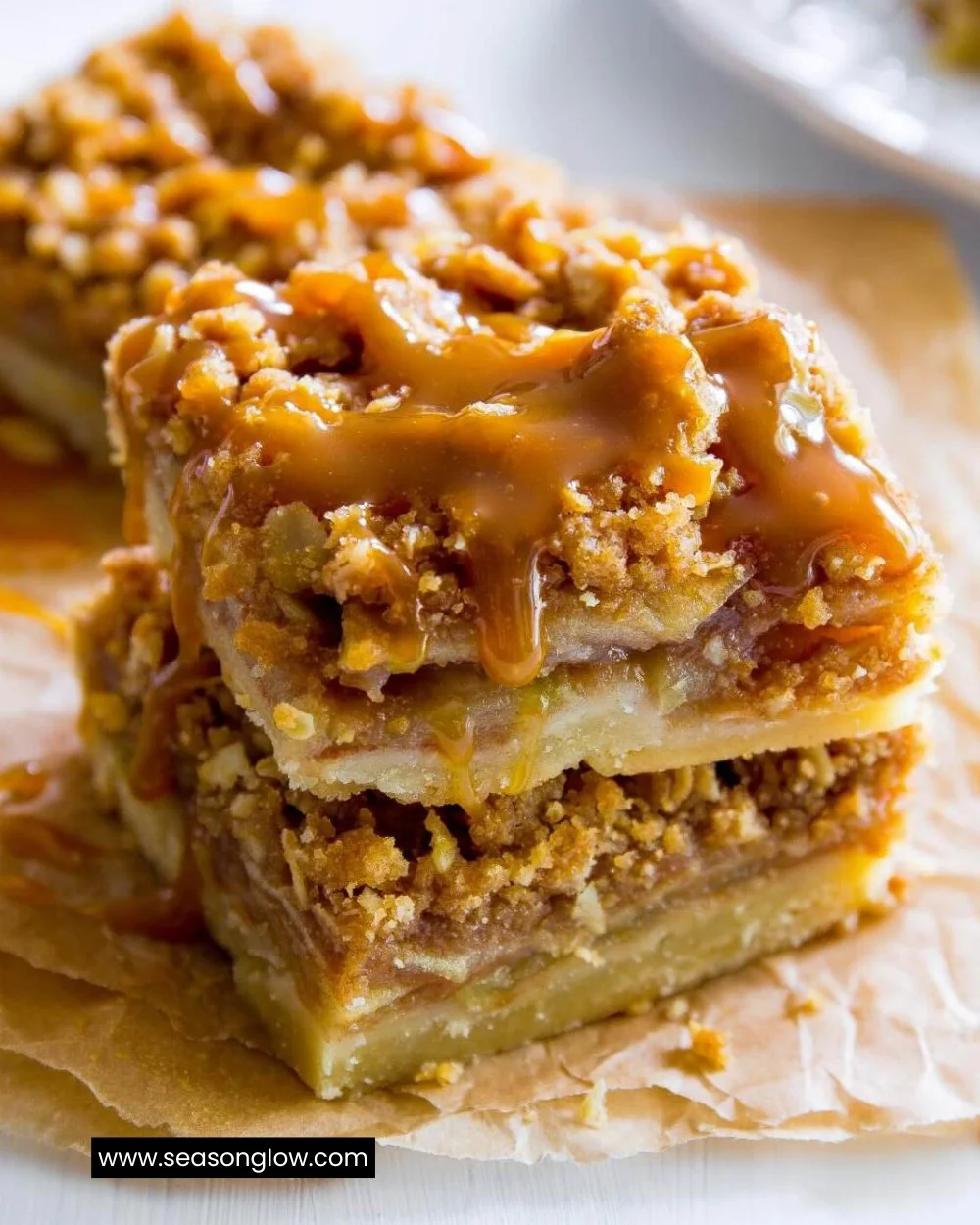 Delicious salted caramel apple pie bars topped with caramel sauce