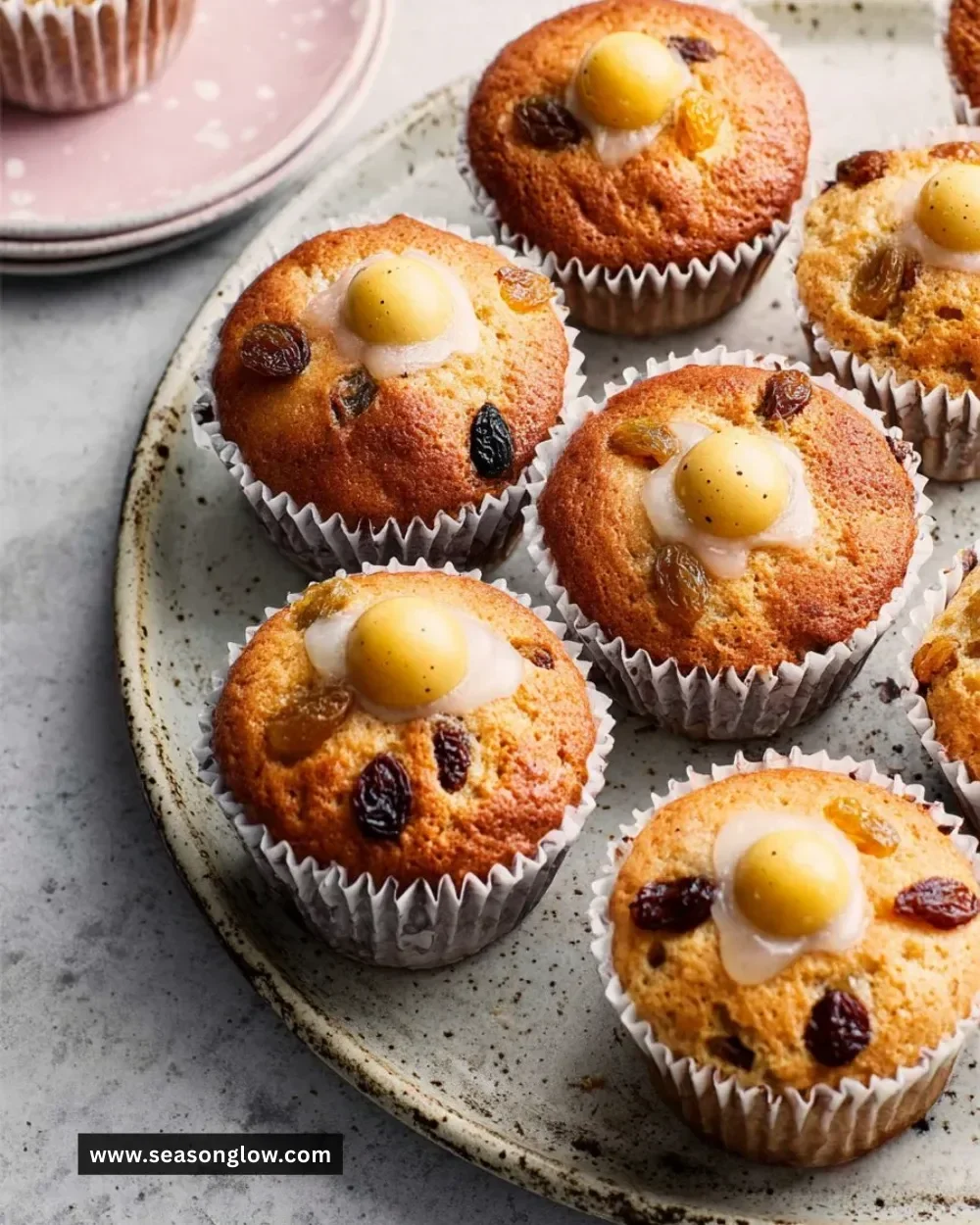 Freshly baked Simnel Muffins topped with marzipan and dried fruit.