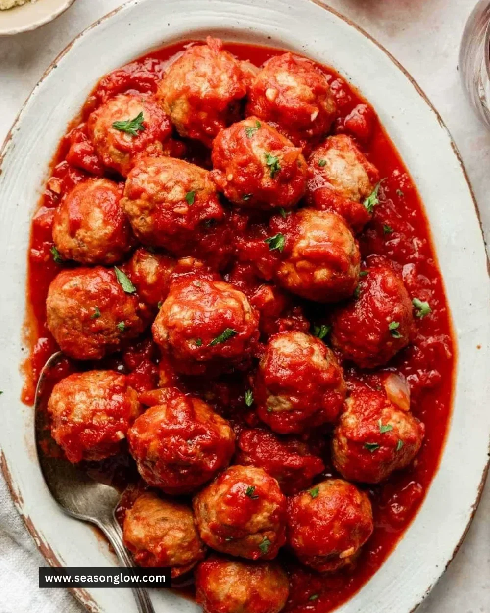 Slow cooker turkey meatballs served with marinara sauce and herbs