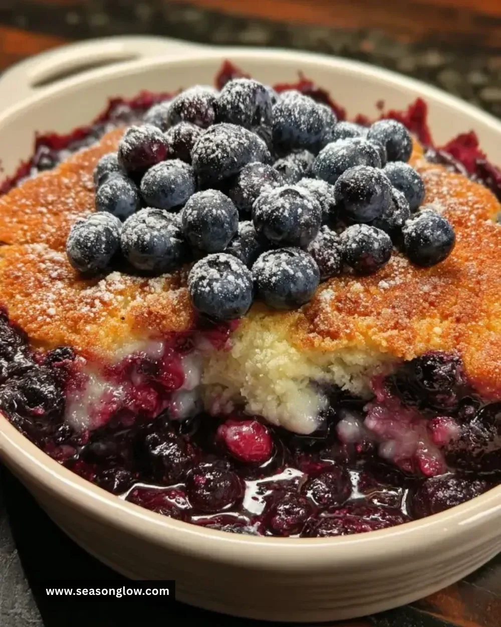 Southern Style Blueberry Cobbler topped with ice cream on a rustic table.