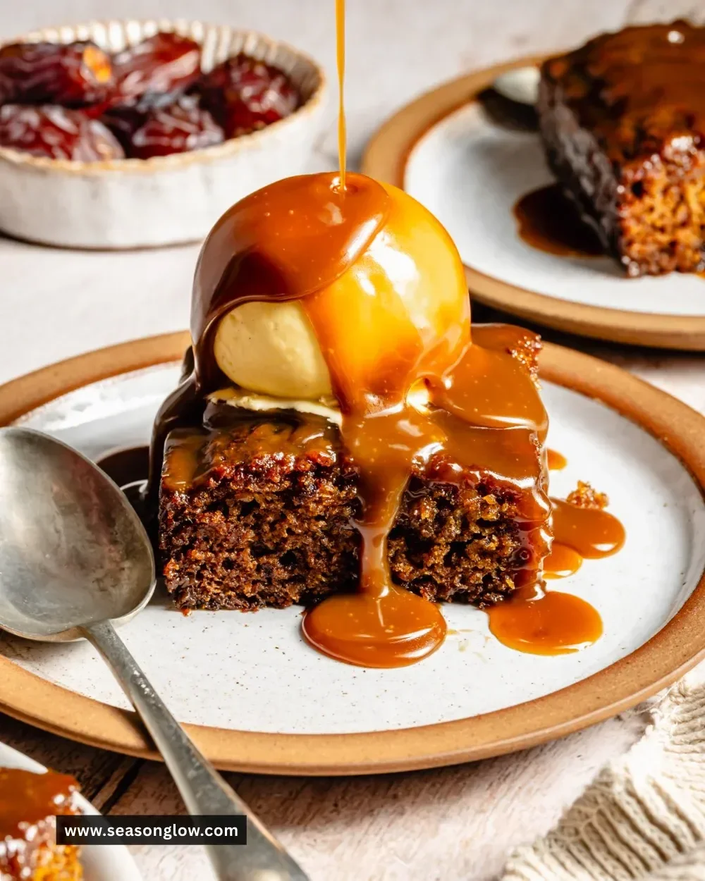 Delicious sticky date cake topped with caramel sauce and served on a plate
