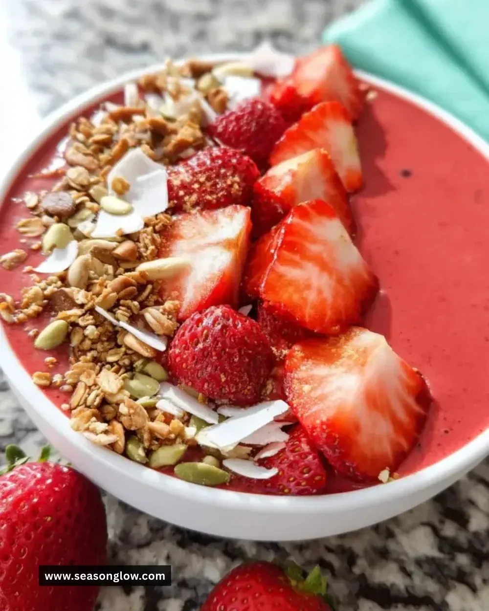 Strawberry smoothie bowl topped with berries and nuts