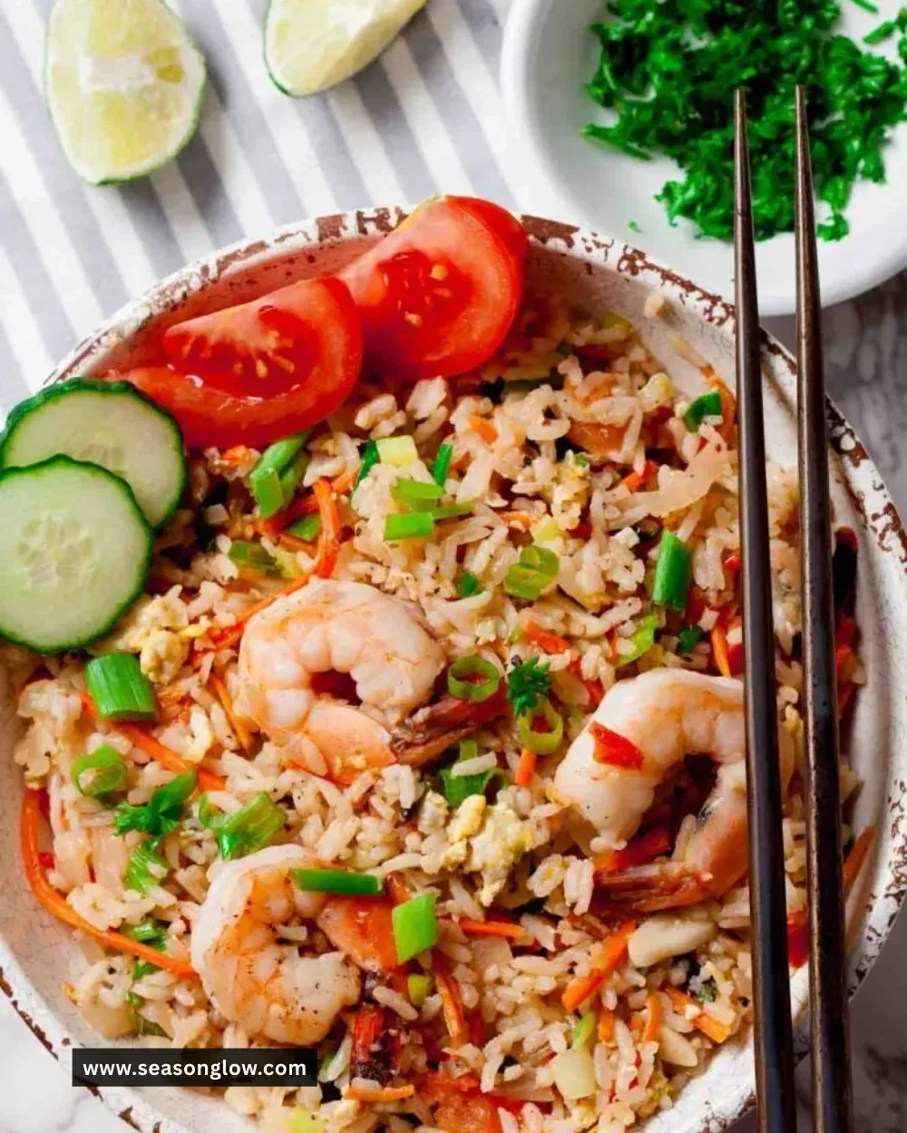 Plate of delicious Thai Fried Rice garnished with vegetables and herbs