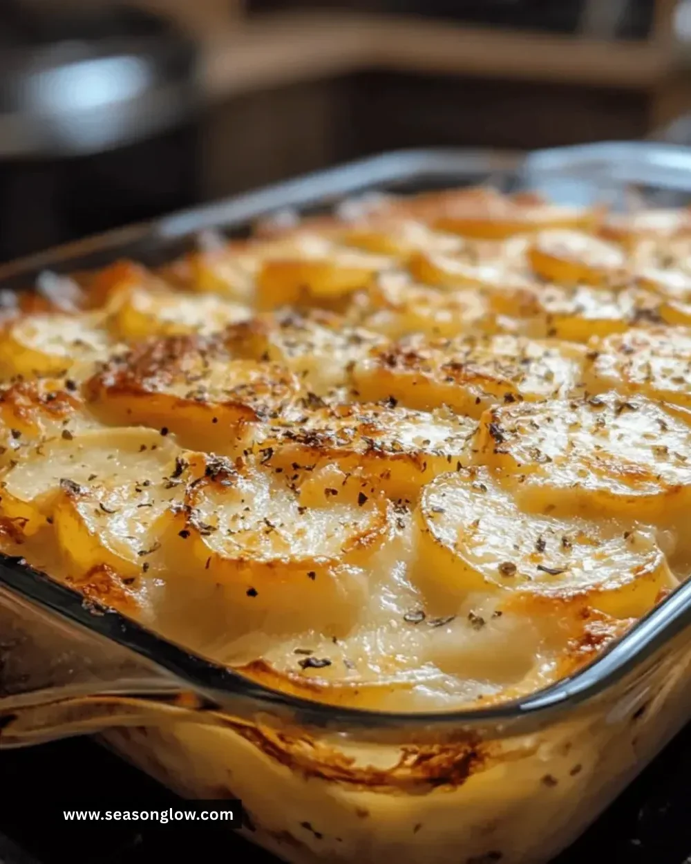 Delicious cheesy scalloped potato bake topped with cheese and herbs