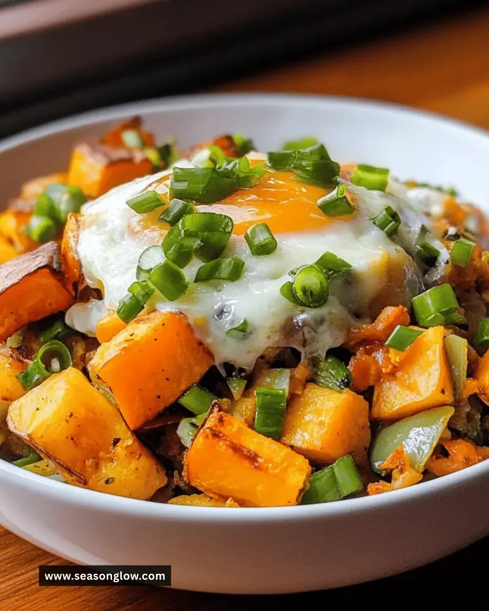 Delicious sweet potato breakfast hash served in a bowl with fresh ingredients.