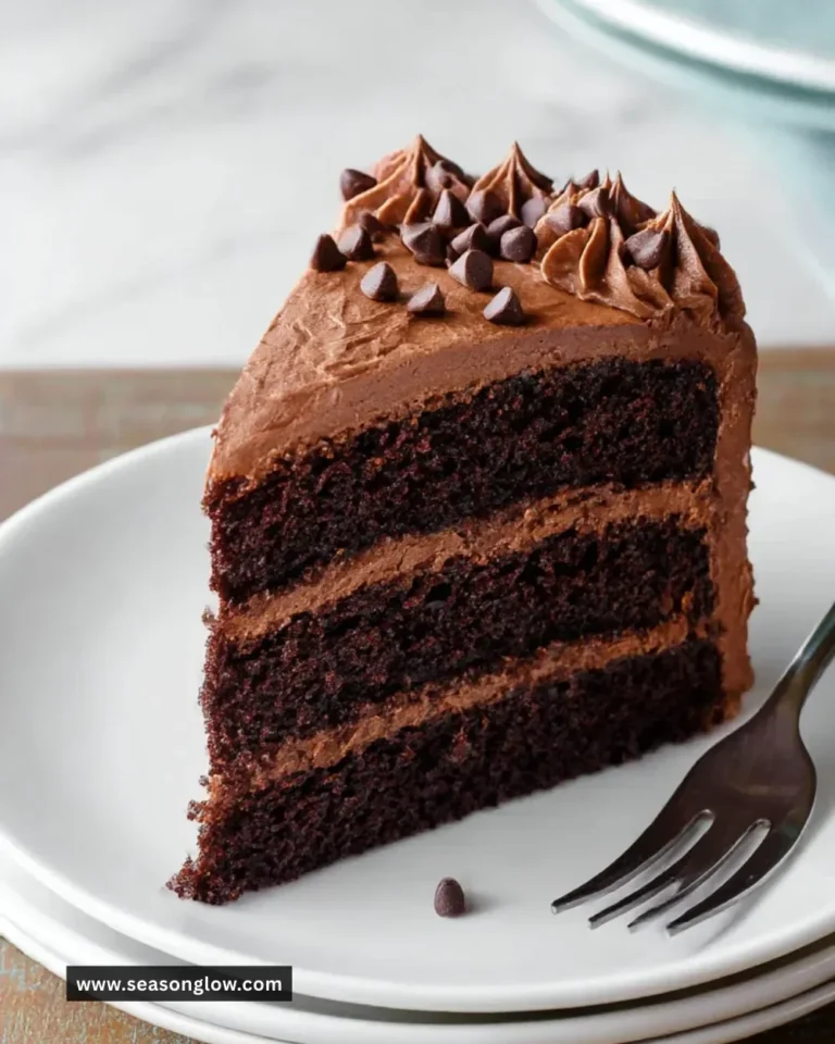 Delicious triple chocolate cake topped with rich chocolate frosting and shavings