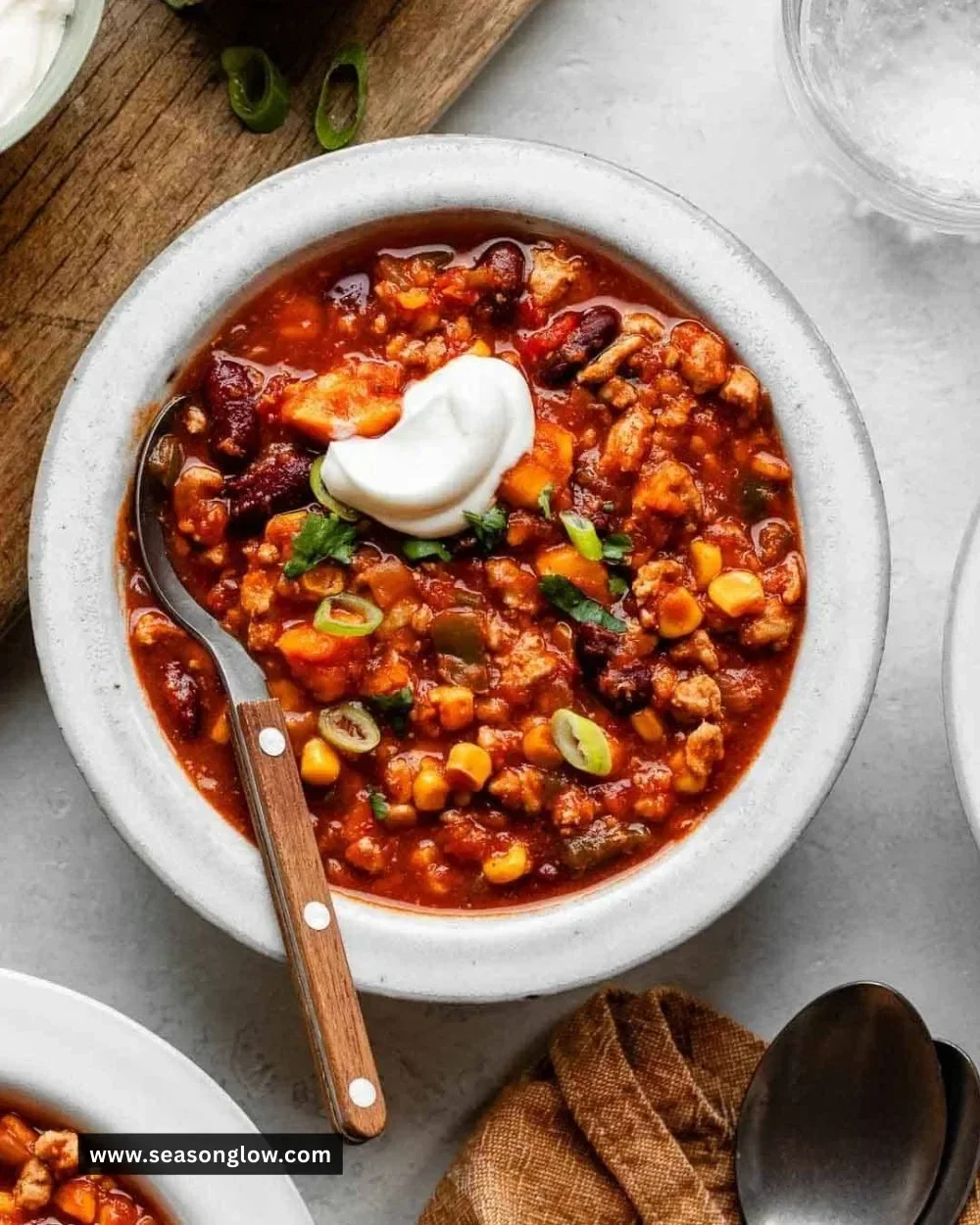 Bowl of turkey sweet potato chili garnished with cilantro and lime