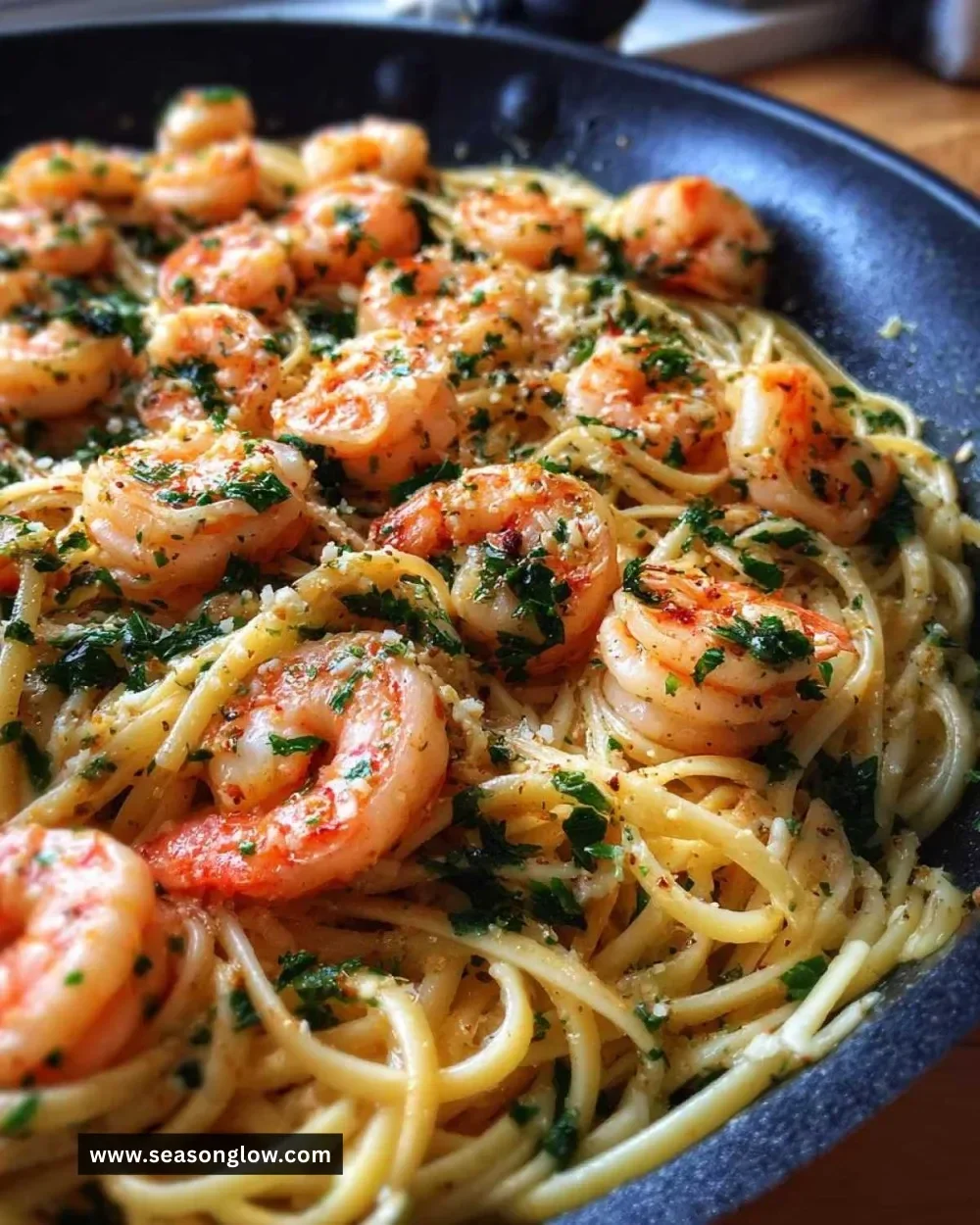 Delicious garlic butter shrimp pasta dish topped with parsley and served in a bowl
