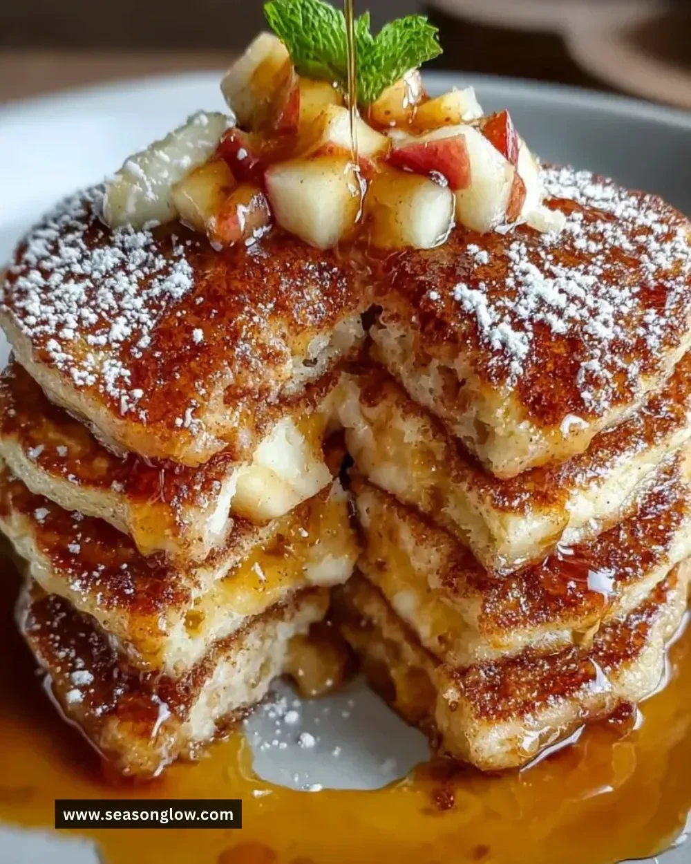 Fluffy apple pie pancakes topped with vanilla maple syrup and apple slices