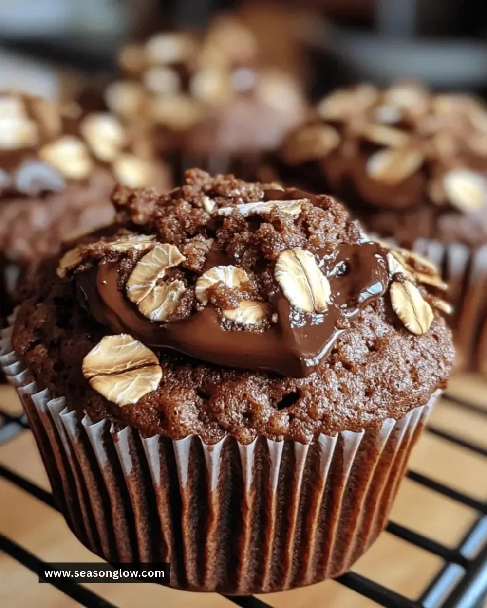 Fluffy chocolate oat muffins displayed on a rustic wooden table