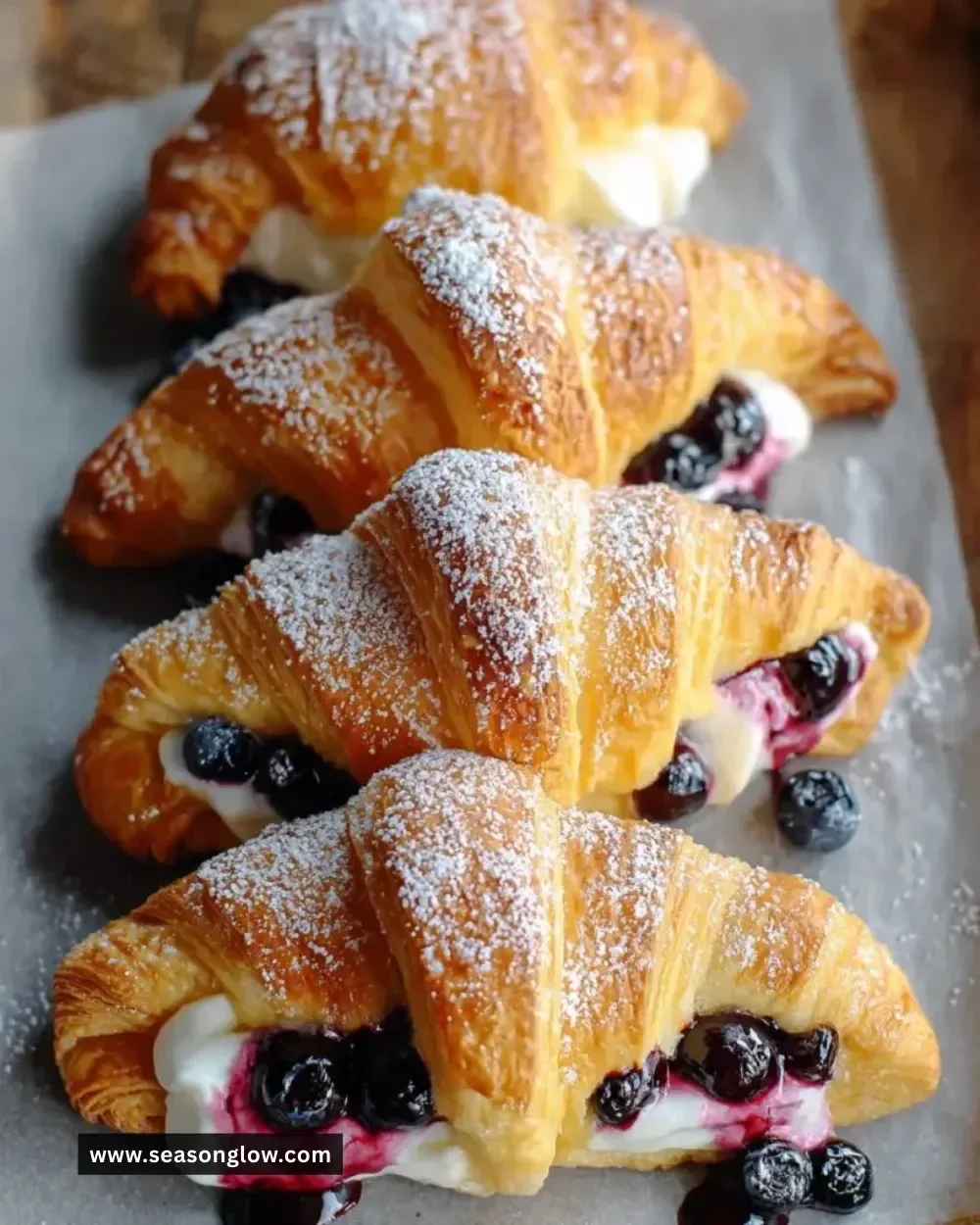 Blueberry cheesecake crescent rolls on a white plate