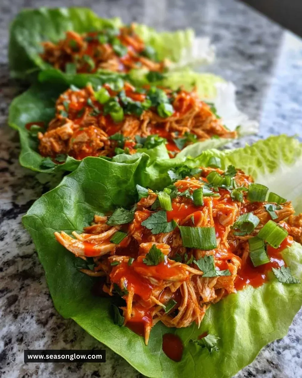 Buffalo Chicken Lettuce Wraps served on a plate with fresh vegetables