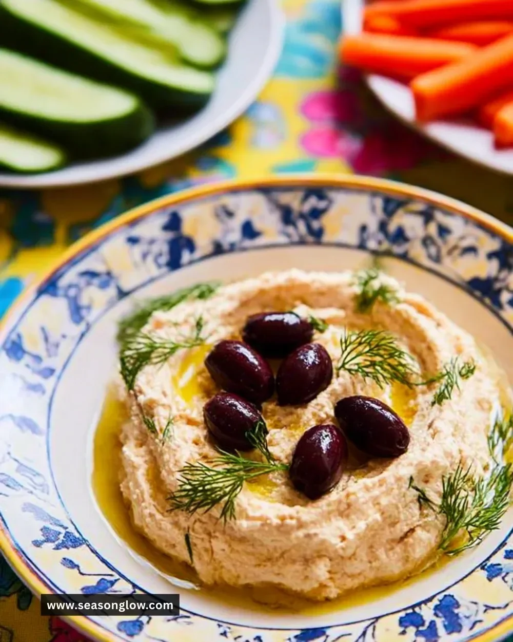 Bowl of Cheat's Taramasalata served with pita bread and garnished with olives.