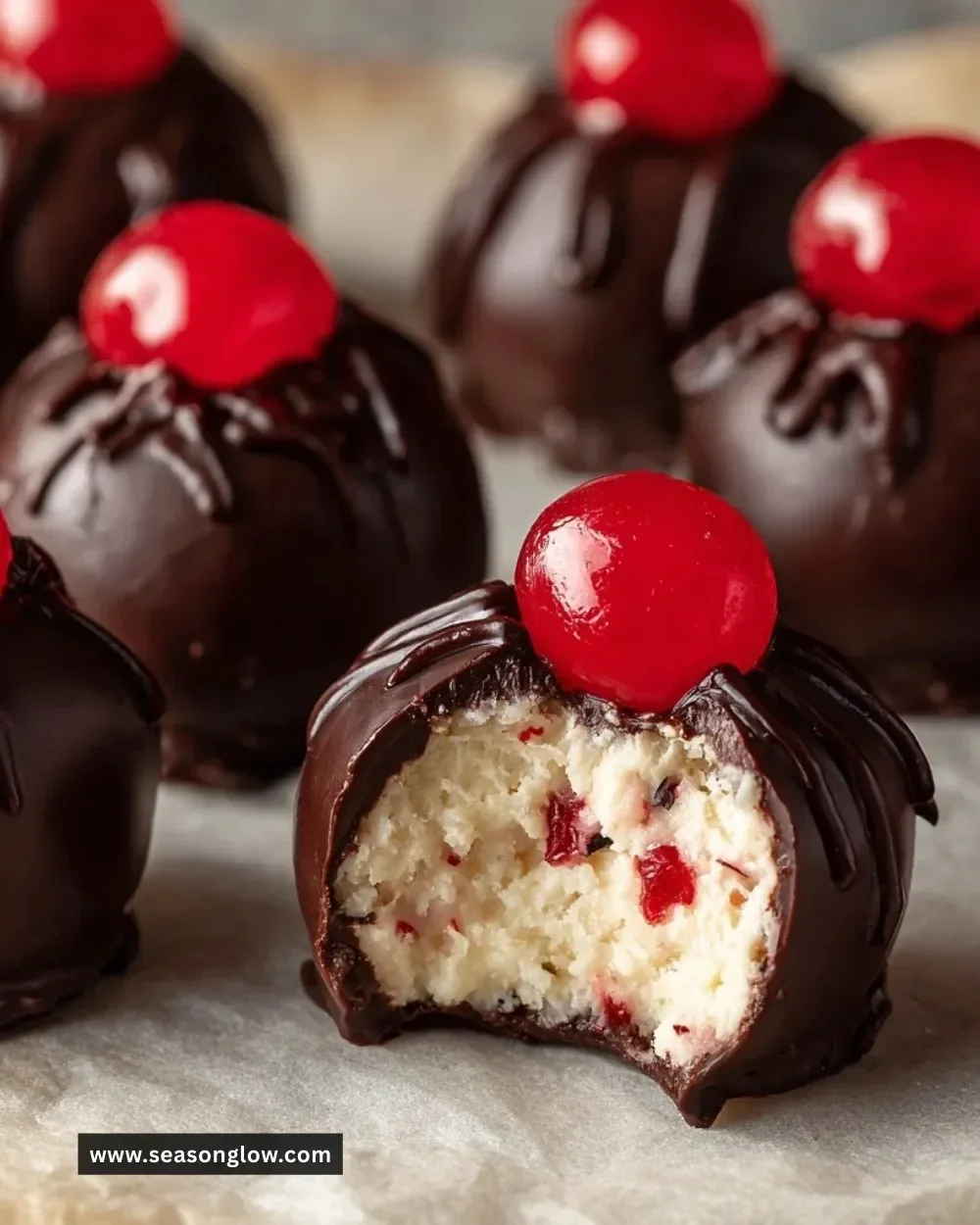 Delicious homemade Cherry Bourbon Balls with chocolate coating and cherries