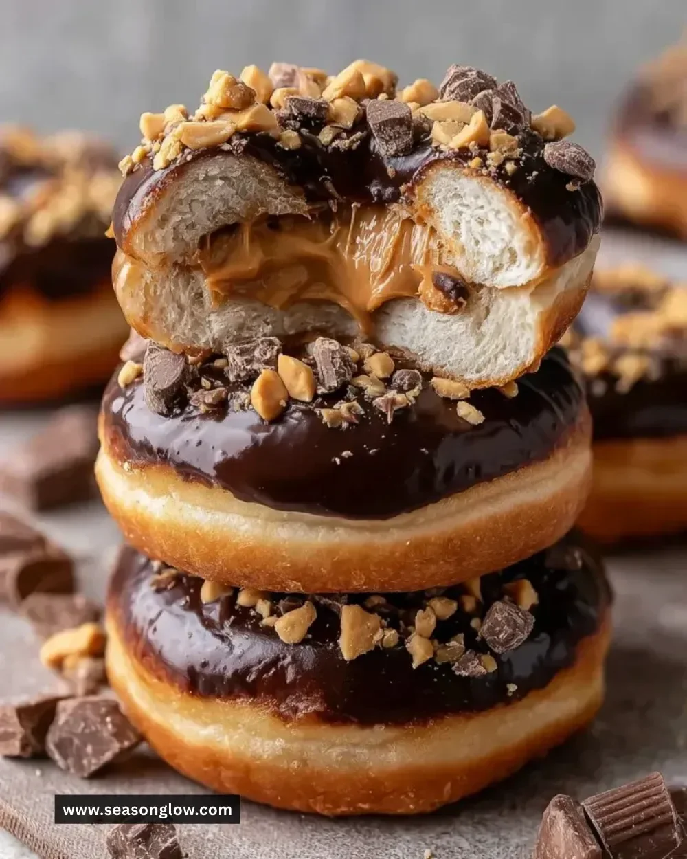 Chocolate peanut butter cup stuffed donuts garnished with chocolate drizzle