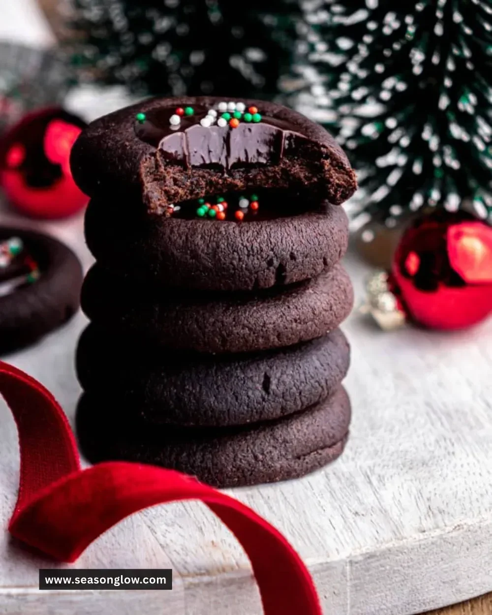Delicious chocolate thumbprint cookies filled with jam and topped with chocolate.