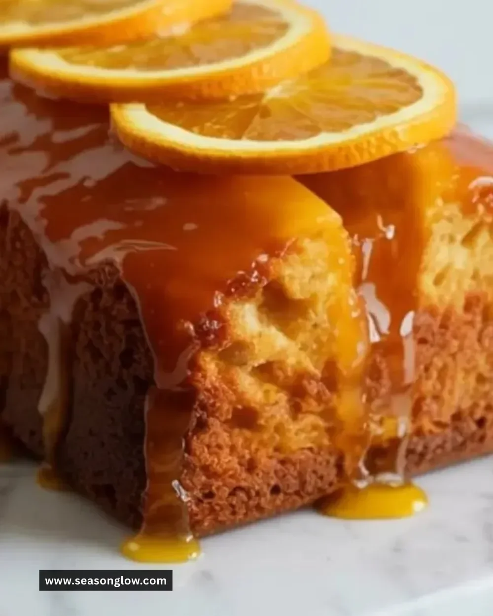 Deliciously moist Christmas Orange Syrup Cake with vibrant orange glaze