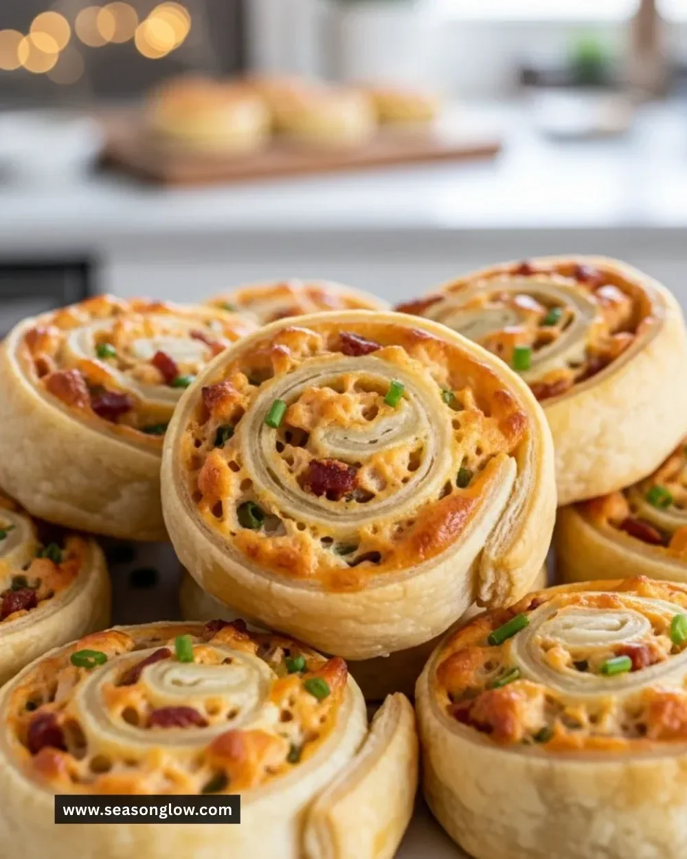 Delicious Crack Chicken Pinwheels appetizer topped with herbs and spices.