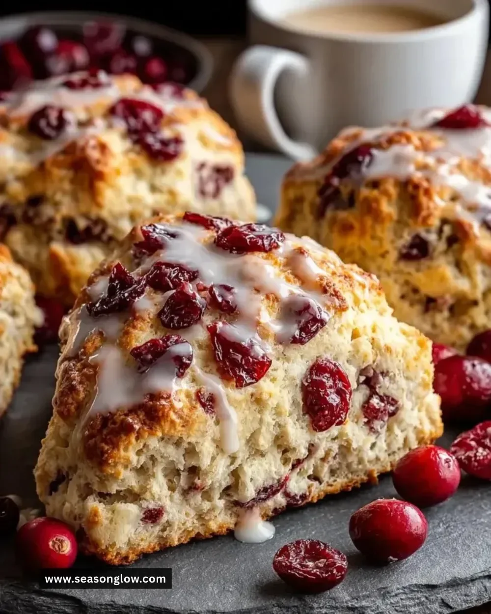Freshly baked Cranberry Orange Maple Scones on a rustic wooden table