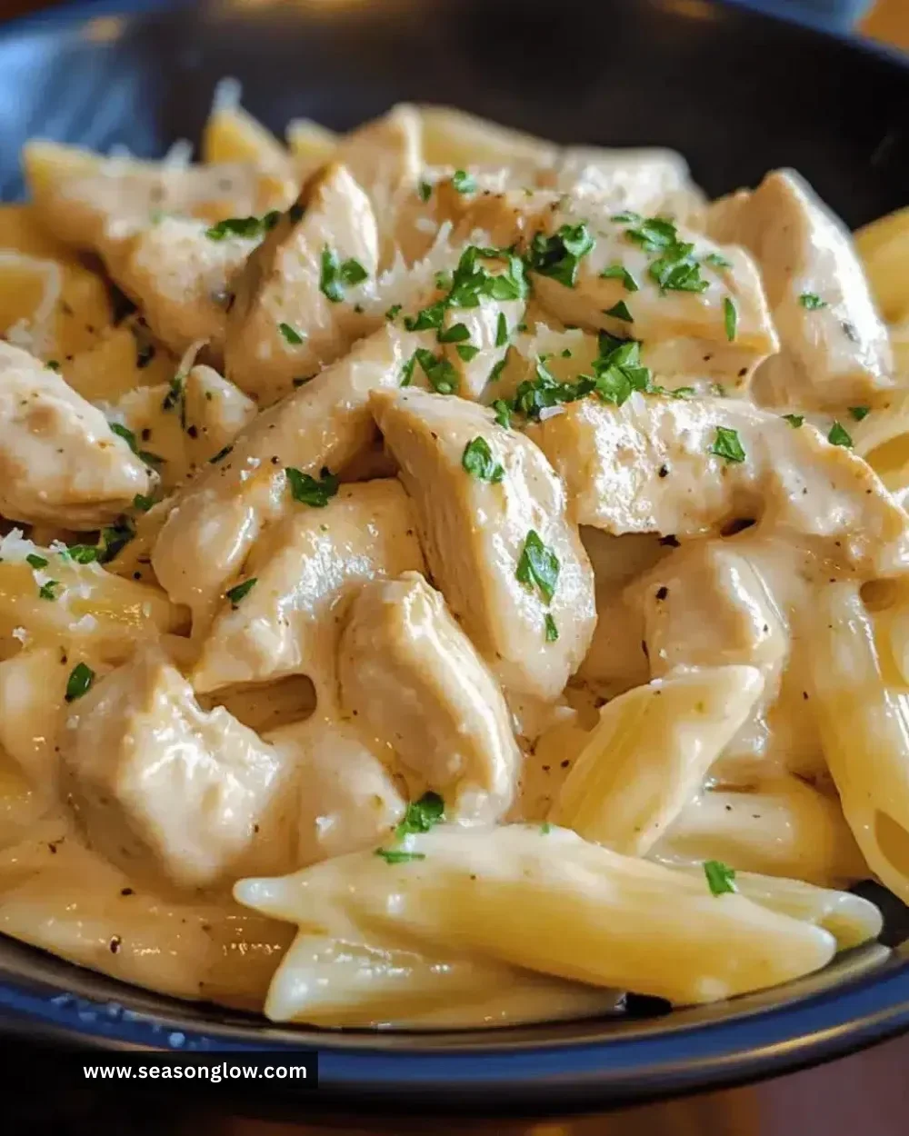 Creamy garlic chicken pasta dish served with herbs and parmesan.