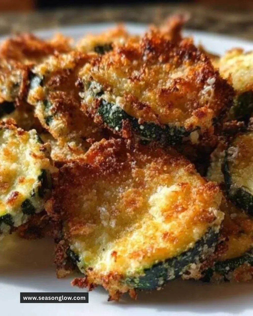 Crispy Zucchini Parmesan Chips served on a plate.