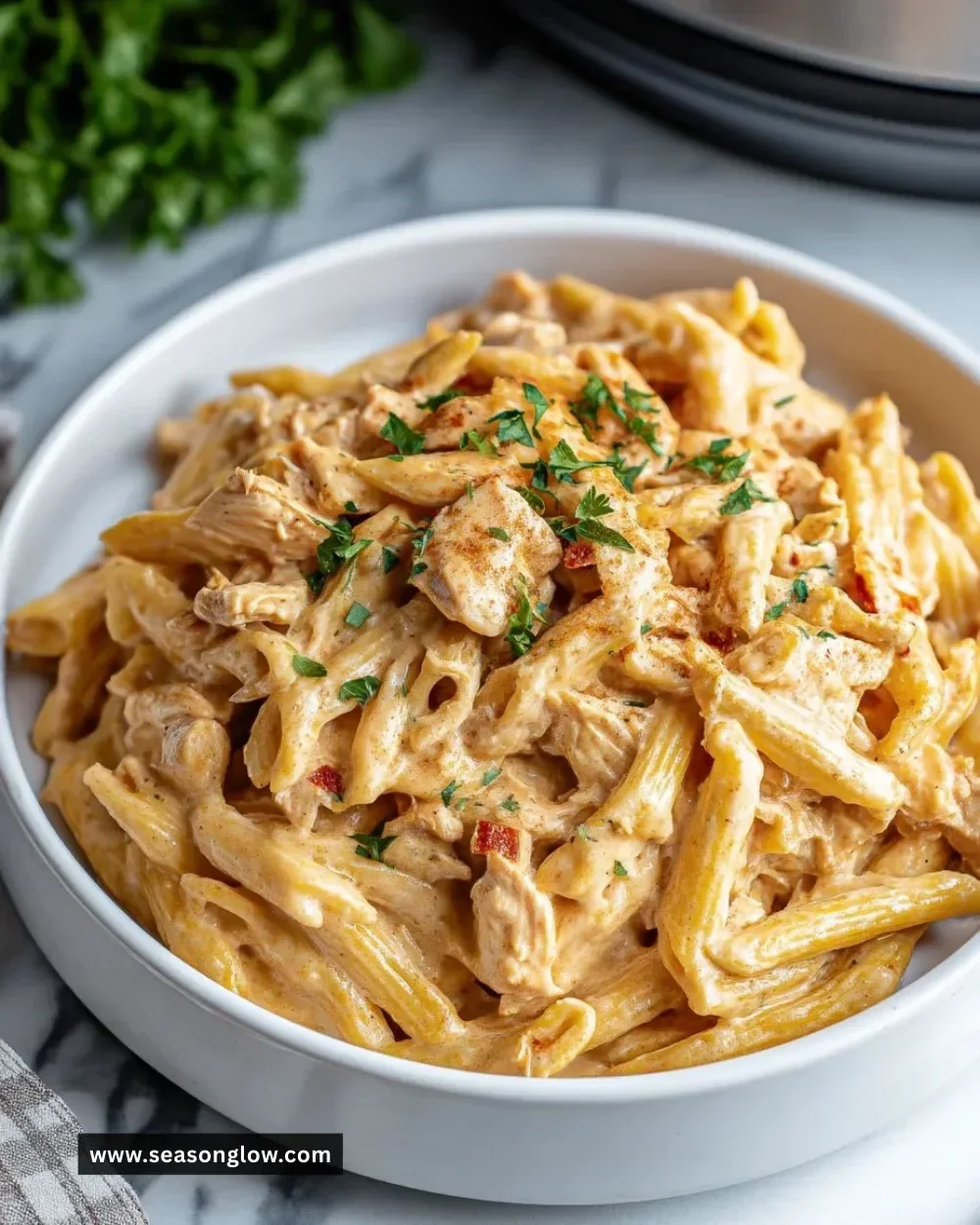 Crock Pot Creamy Cajun Chicken Pasta with vibrant spices and creamy sauce.