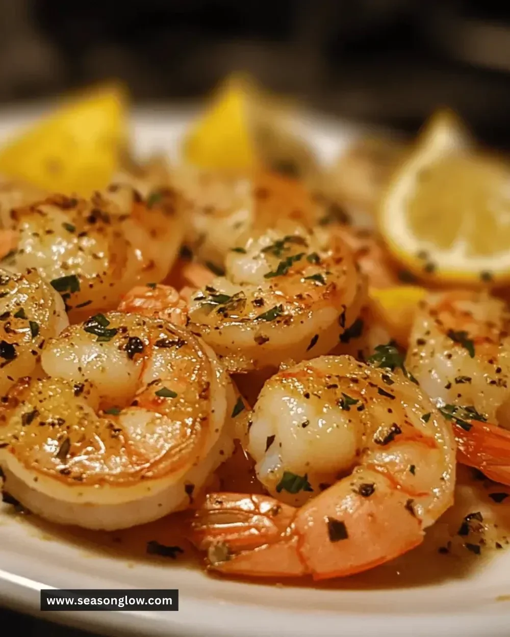 Plate of easy lemon garlic herb shrimp garnished with fresh herbs.