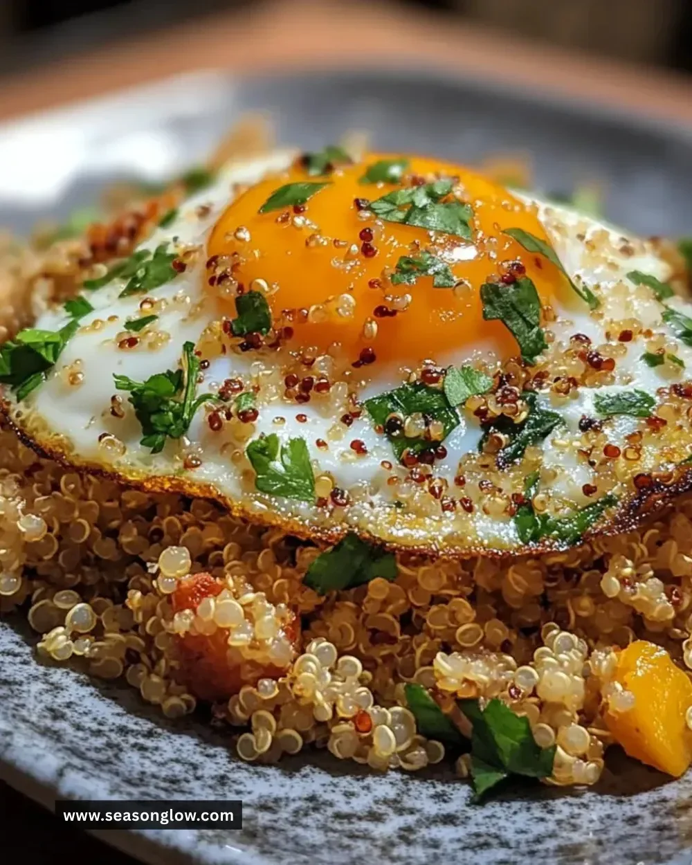 Easy savory egg fried quinoa served in a bowl with vegetables