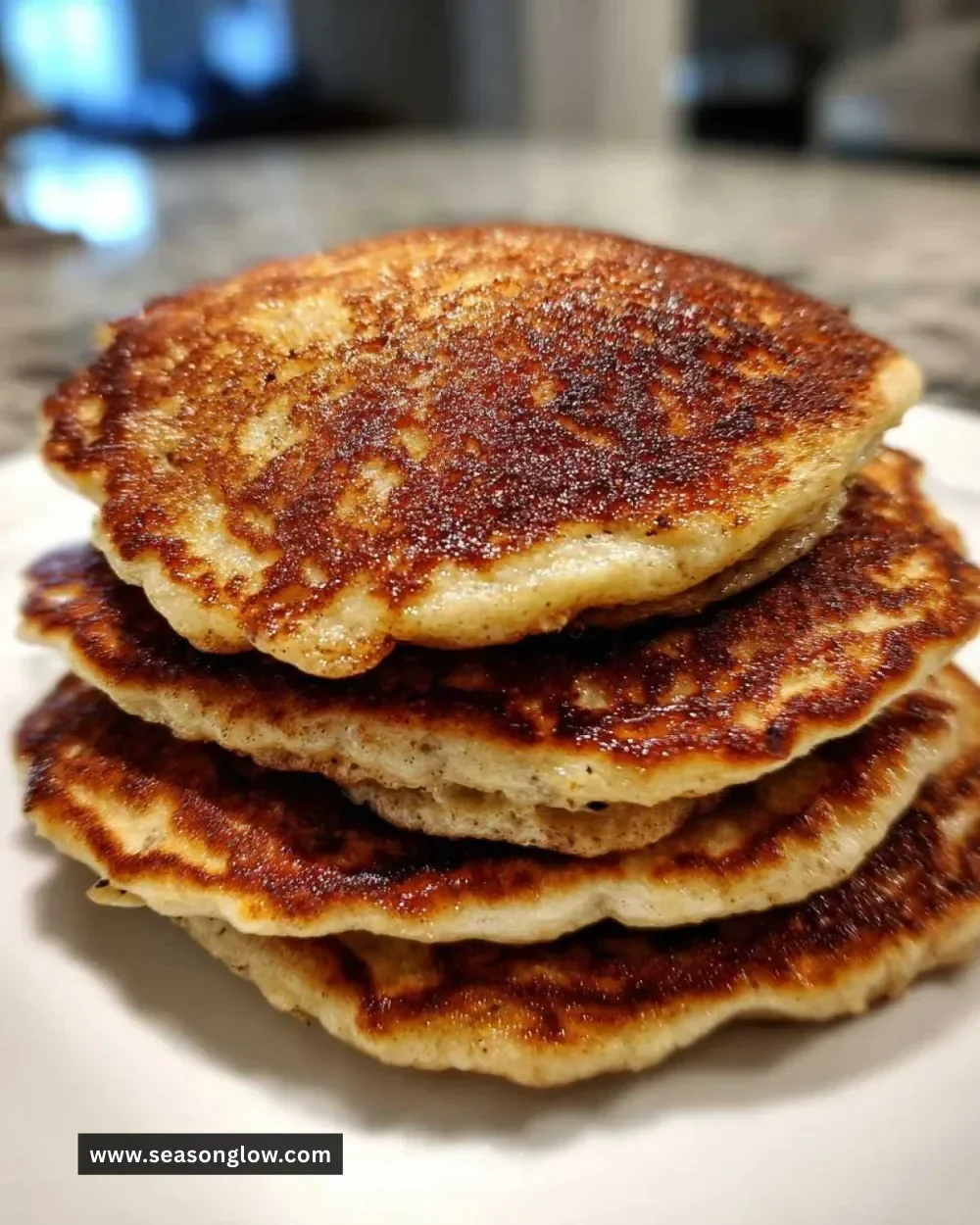 Fluffy banana bread pancakes topped with syrup and banana slices
