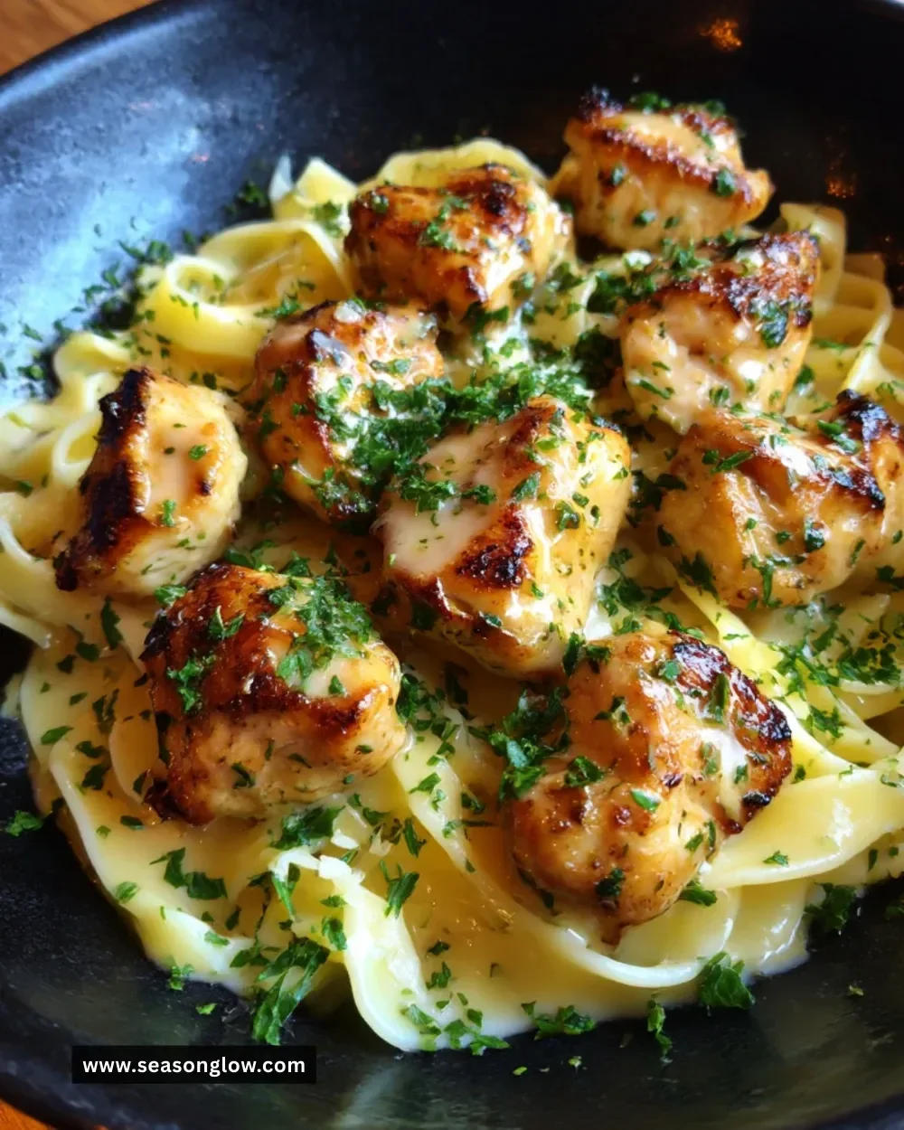 Delicious Garlic Butter Chicken Bites served with creamy Parmesan pasta.