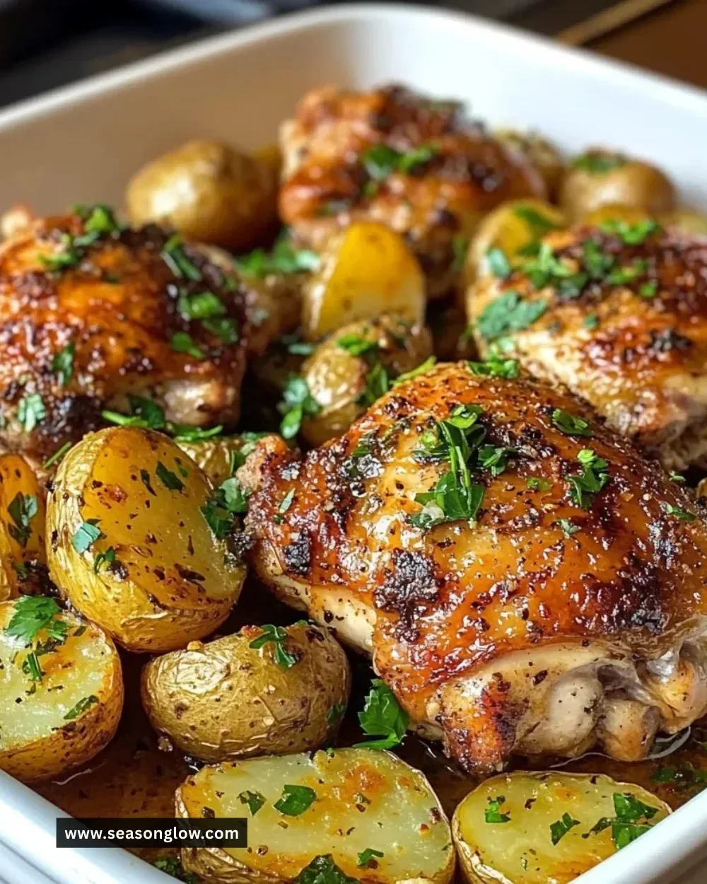 Garlic herb roasted chicken thighs with baby potatoes on a plate