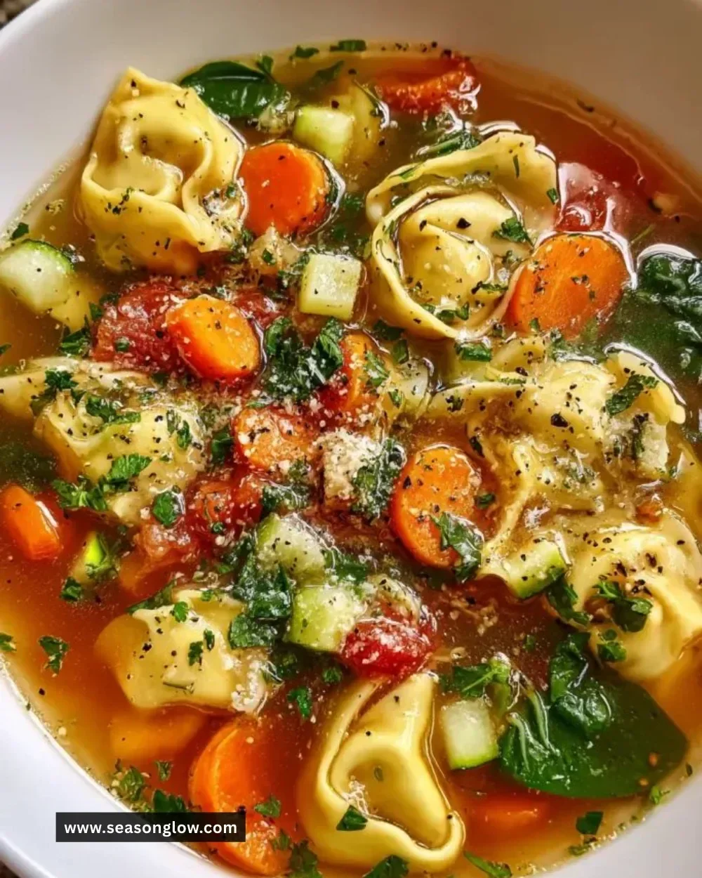 Bowl of healthy Tortellini Soup with vegetables and herbs