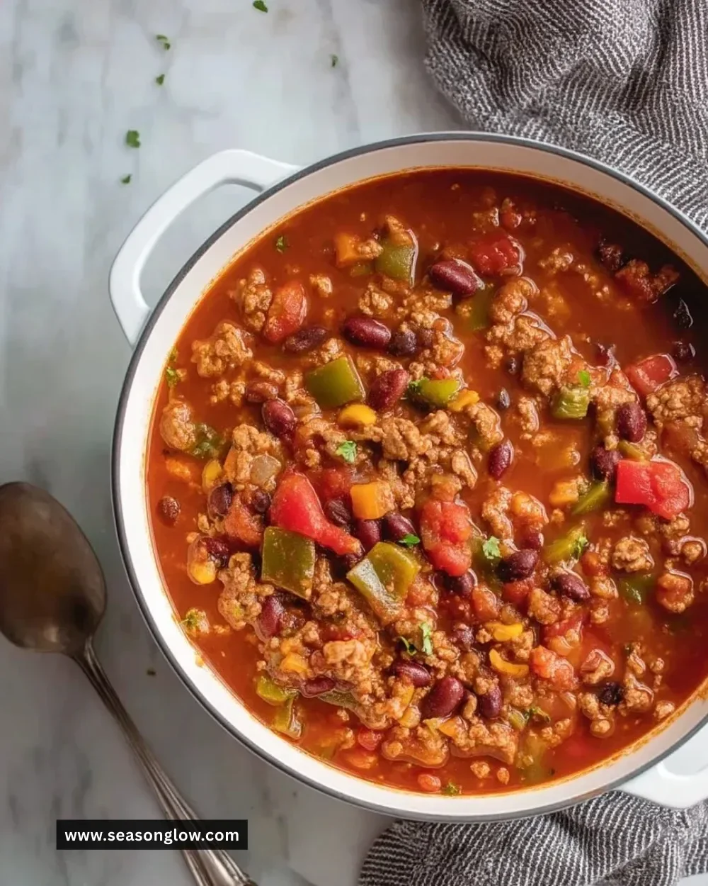 Bowl of hearty turkey vegetable chili topped with fresh herbs