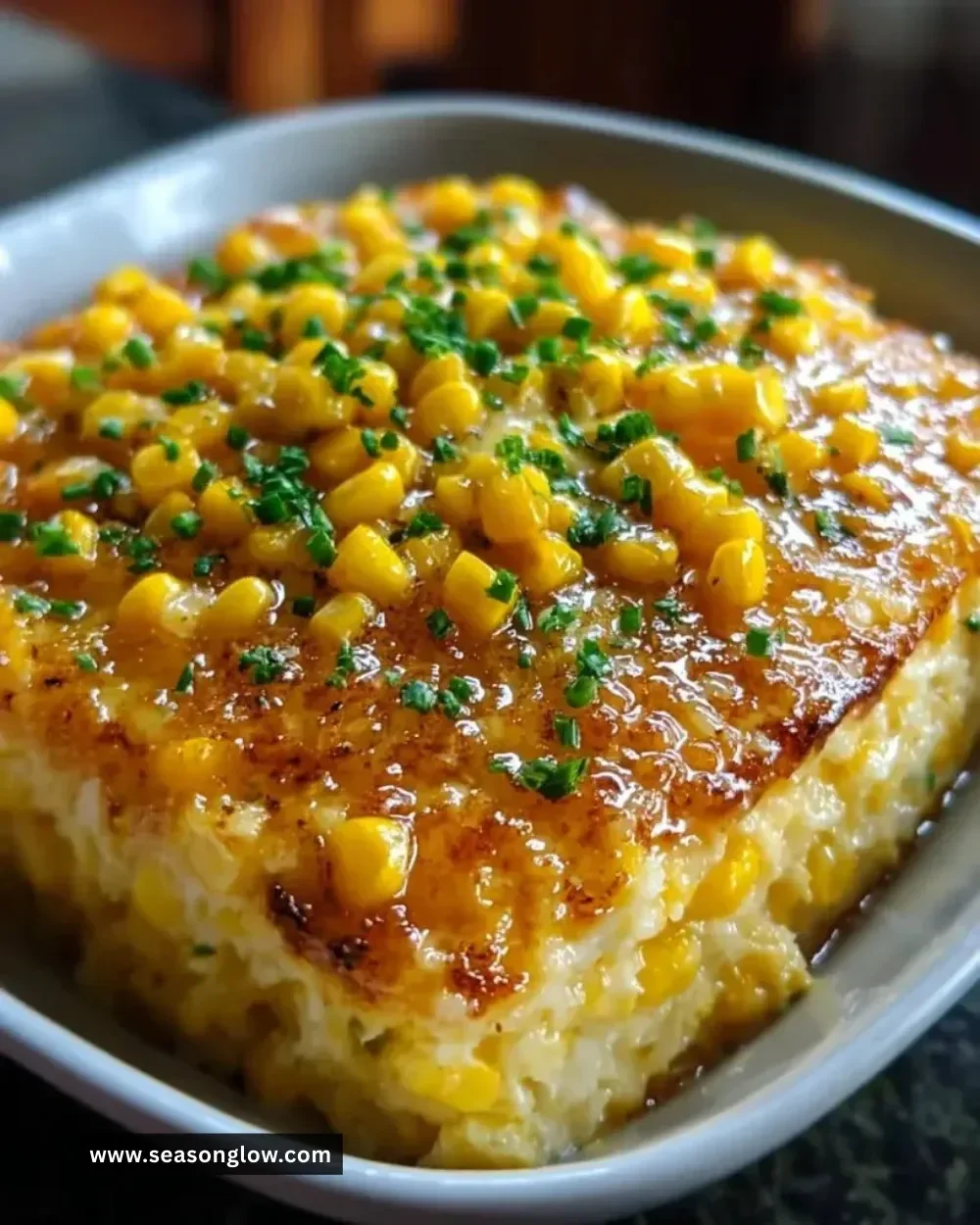 Honey-Glazed Corn Casserole served in a baking dish, showcasing golden corn and a glaze.