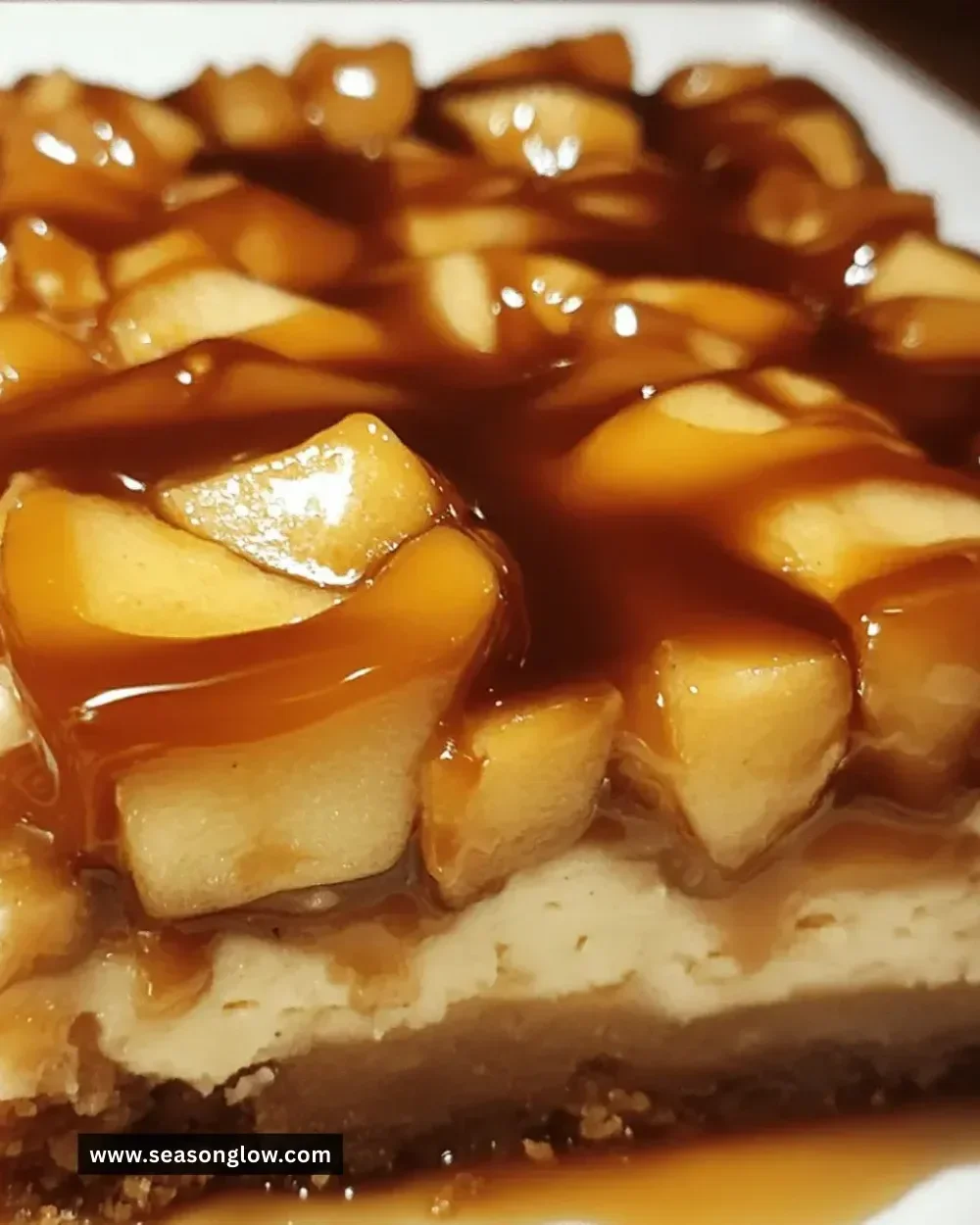 Irresistible salted caramel apple cheesecake bars topped with caramel sauce