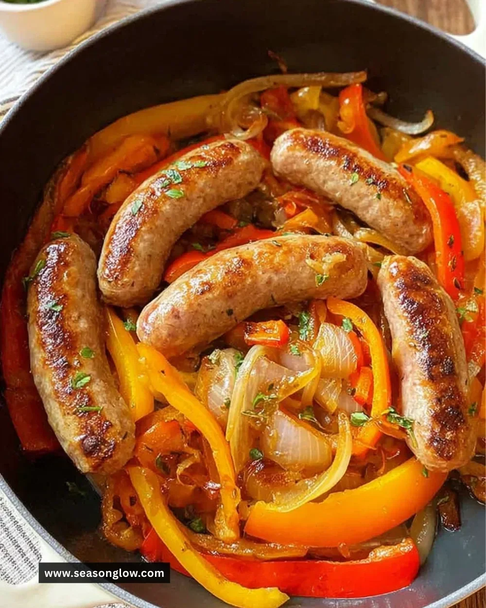 Italian sausage with sautéed peppers and onions served in a pan