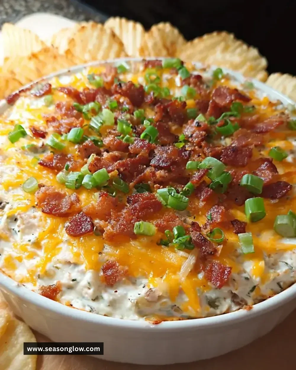 Delicious loaded baked potato dip served in a bowl with toppings