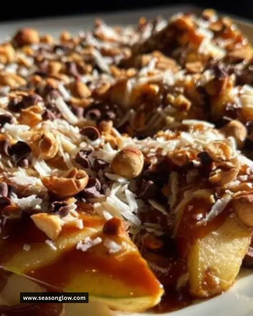 Delicious apple nachos topped with caramel and toppings served on a plate