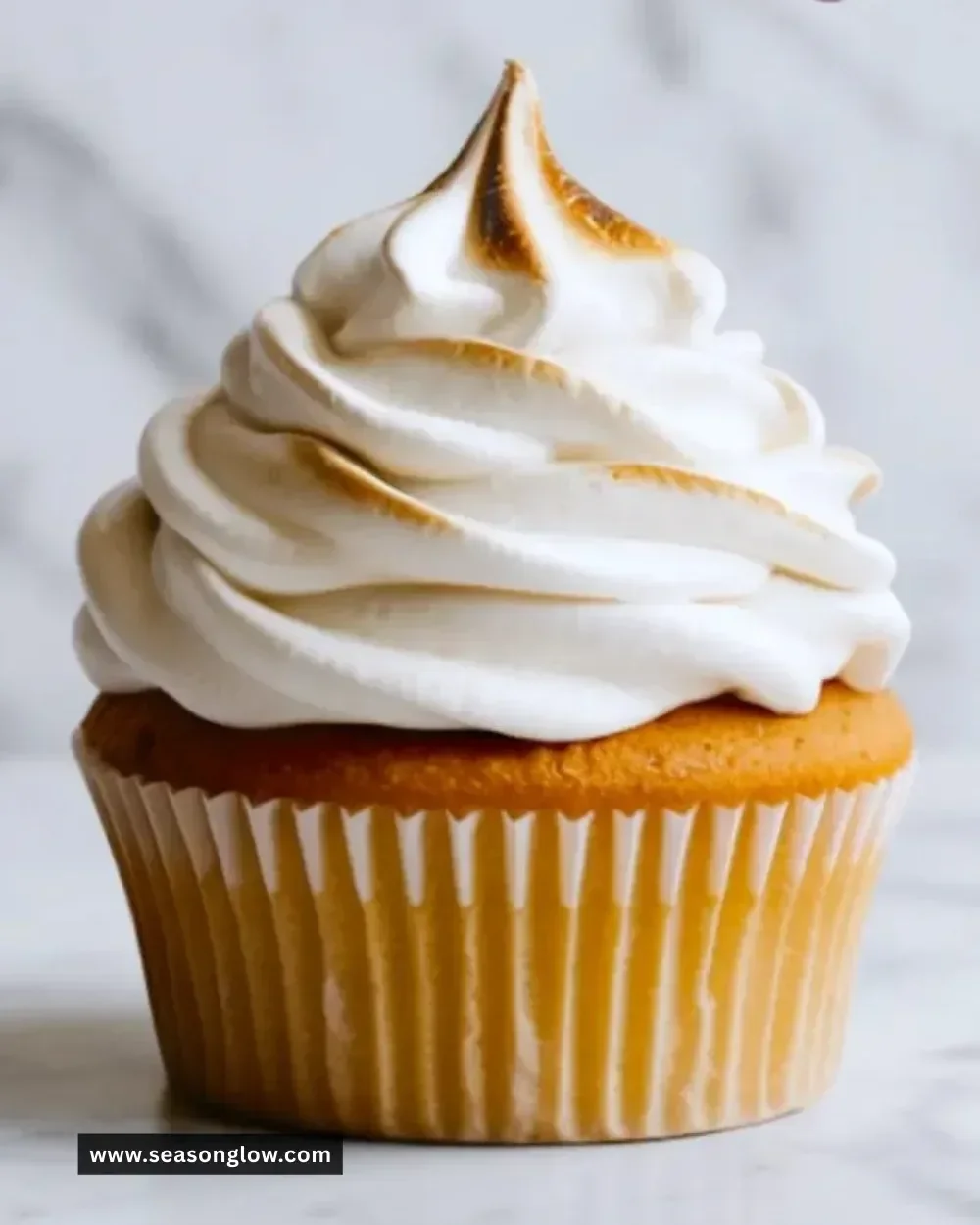 Delicious marshmallow frosting spread over a chocolate cupcake.