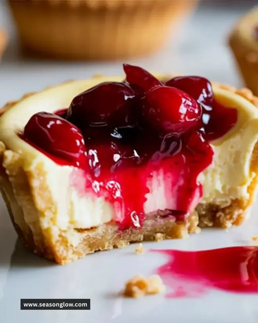 Mini cranberry cheesecake tarts on a decorative plate
