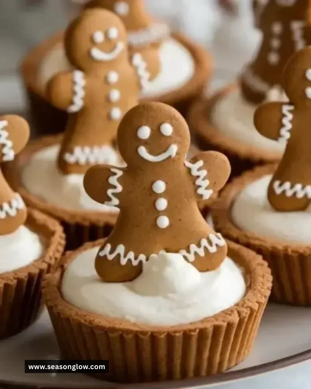 Delicious no-bake gingerbread cheesecake cups topped with holiday spices.