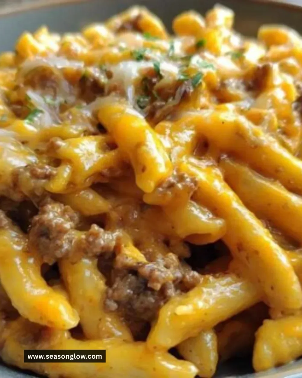 One-Pot Cheeseburger Pasta in a skillet topped with cheese and parsley