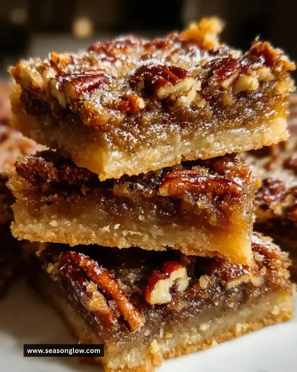 Delicious pecan pie bars with a gooey filling and nutty topping.