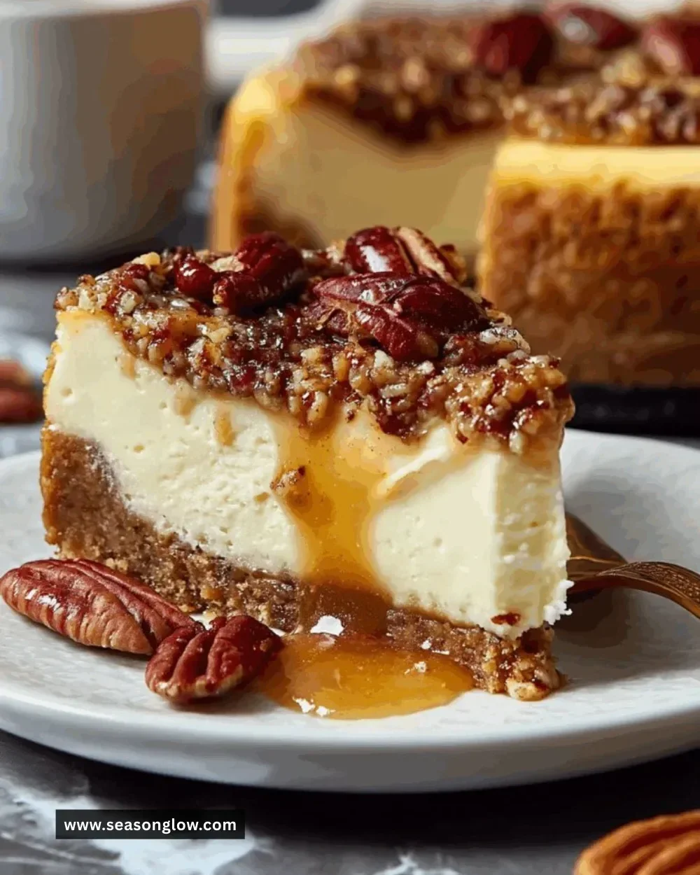 Delicious slice of pecan pie cheesecake topped with caramel and pecans