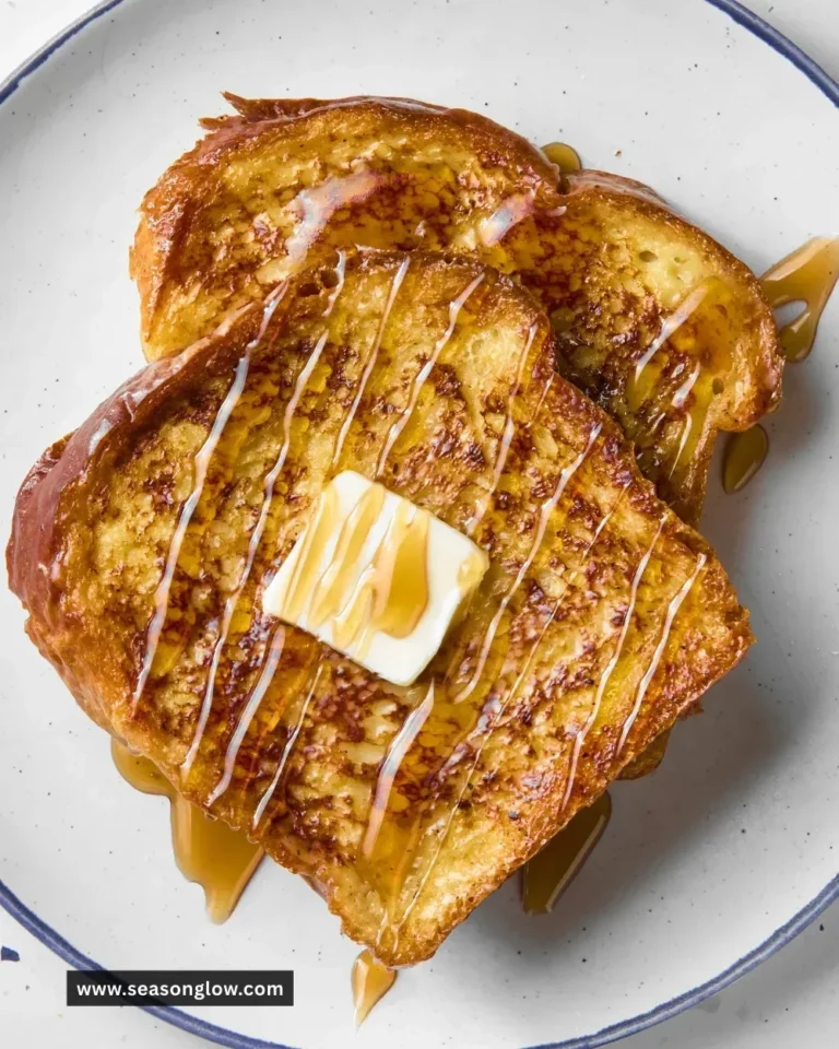 Delicious plate of classic French toast topped with syrup and berries.