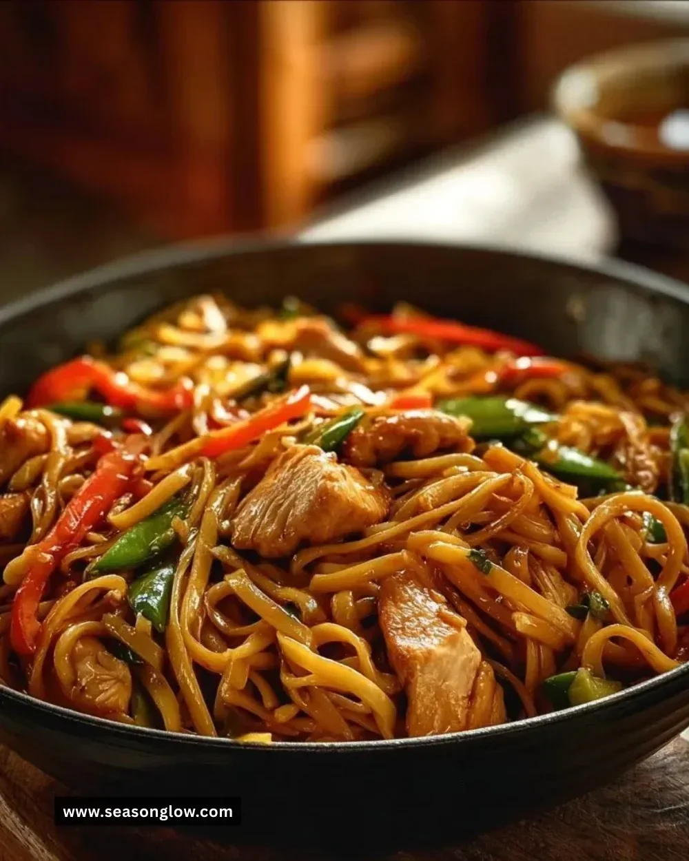 Delicious quick and easy Chicken Lo Mein served in a bowl with vegetables and noodles.